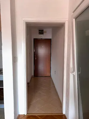 an empty hallway with a door and a tile floor at Sunset Bay Budva in Budva