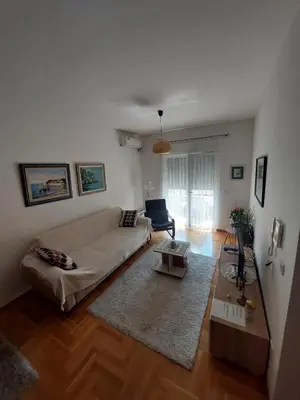 a living room with a couch and a table at Cozy Apartment Perfect for Vacation in Budva
