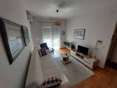 a living room with a couch and a tv at Cozy Apartment Perfect for Vacation in Budva