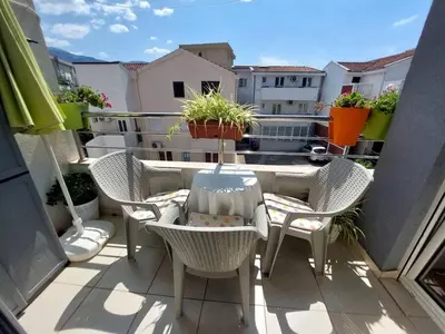 a balcony with chairs and a table on a balcony at Cozy Apartment Perfect for Vacation in Budva