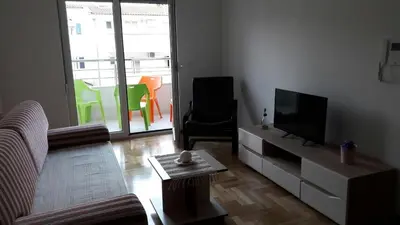 a living room with a couch and a tv at Cozy Apartment Perfect for Vacation in Budva