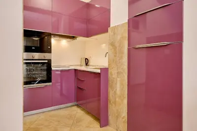 a kitchen with purple cabinets and counters at Vista Mare Apartments in Budva