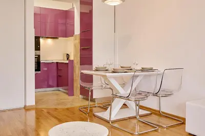 a dining room with a white table and chairs at Vista Mare Apartments in Budva