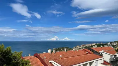 a view of the ocean from the roofs of buildings at Apartment Jasovic in Ulcinj