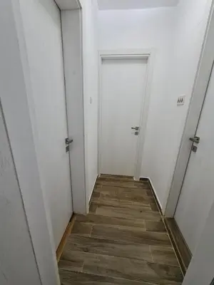 an empty hallway with two doors and a wooden floor at Apartment Jasovic in Ulcinj