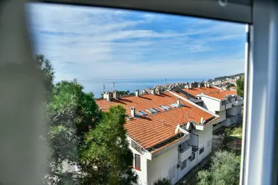 a view of the roofs of buildings and the ocean at Apartment Jasovic in Ulcinj