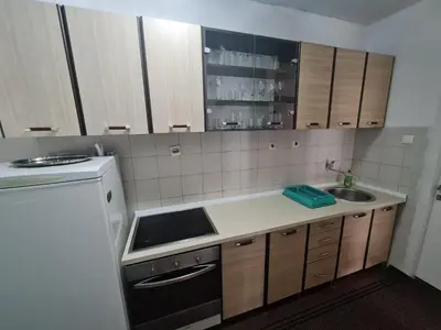 a small kitchen with a sink and a stove at Apartment Jasovic in Ulcinj