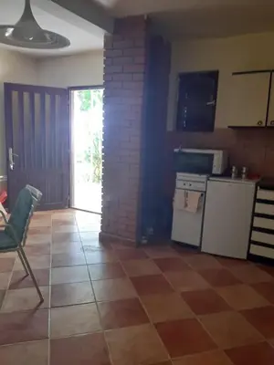 a kitchen with a tiled floor with a stove and refrigerator at Kruce accommodation in Ulcinj