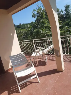 a chair sitting on a porch with a view at Kruce accommodation in Ulcinj