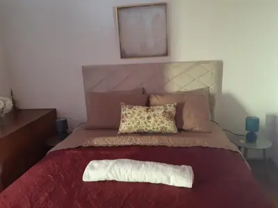 a bed with a white pillow on top of it at Kruce accommodation in Ulcinj