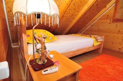 a bedroom with a bed and a table with a lamp at Vikendica na obali rijeke Bojane sa velikim dvoristem, parkingom ljetnjom kuhinjom i mjestom za rostilj in Ulcinj