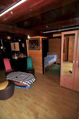 a living room with a couch and a chair and a bed at Vikendica na obali rijeke Bojane sa velikim dvoristem, parkingom ljetnjom kuhinjom i mjestom za rostilj in Ulcinj