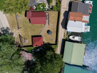 an overhead view of a group of houses next to the water at Vikendica na obali rijeke Bojane sa velikim dvoristem, parkingom ljetnjom kuhinjom i mjestom za rostilj in Ulcinj