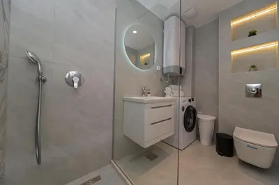 a bathroom with a shower and a toilet and a sink at Apartment Ejna in Dobra Voda