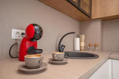 a kitchen with two cups of coffee on a counter at Apartment Ejna in Dobra Voda