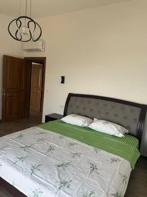 a bedroom with a bed with a green and white comforter at Salakovic Country Estate in Bar