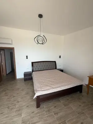 a bedroom with a bed and a chandelier at Salakovic Country Estate in Bar