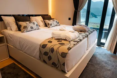 a bedroom with two beds with towels on them at Apartman Katica in Becici