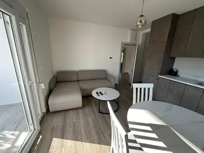 a living room with a couch and a table at Apartmani Aki 6 in Sutomore