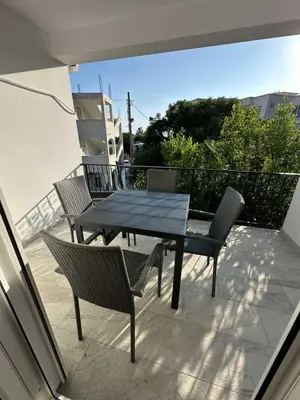 a patio with a table and chairs on a balcony at Apartmani Aki 6 in Sutomore