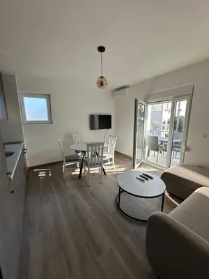 a living room with a couch and a table at Apartmani Aki 6 in Sutomore