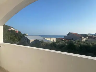 a view of the ocean from the balcony of a house at Peaceful Apartment with a Sea View, in Becici in Becici