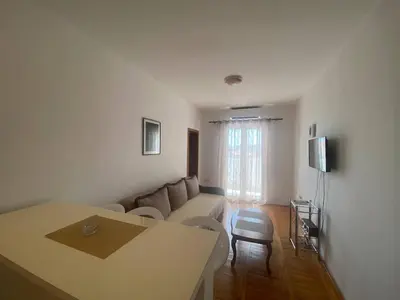 a living room with a couch and a table at Peaceful Apartment with a Sea View, in Becici in Becici