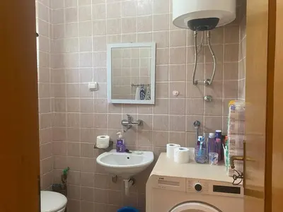 a bathroom with a sink and a toilet and a mirror at Peaceful Apartment with a Sea View, in Becici in Becici