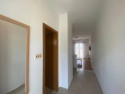 an empty hallway with a door to a room at Peaceful Apartment with a Sea View, in Becici in Becici