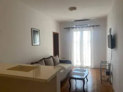 a living room with a couch and a table at Peaceful Apartment with a Sea View, in Becici in Becici