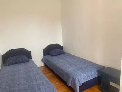 a bedroom with two beds and a dresser at Peaceful Apartment with a Sea View, in Becici in Becici
