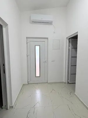 an empty room with a door and a window at Apartmani Kula in Pečurice
