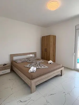 a bedroom with a bed with two towels on it at Apartmani Kula in Pečurice
