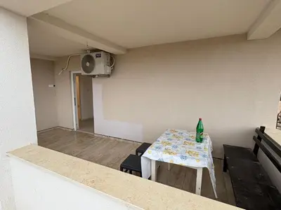 a small room with a table with a bottle on it at Apartmani Kula in Pečurice