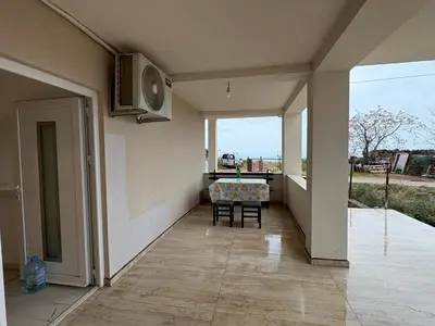 a dining room with a table and a window at Apartmani Kula in Pečurice