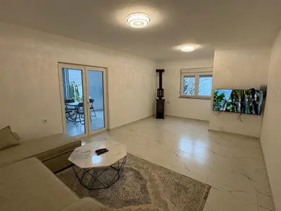 a living room with a couch and a table at Apartmani Kula in Pečurice
