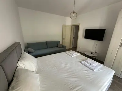 a small bedroom with a bed and a couch at Apartmani Aki 4 in Bar
