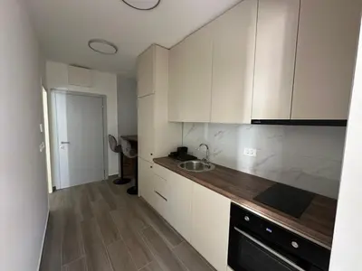 a kitchen with white cabinets and a sink at Apartmani Aki 4 in Bar