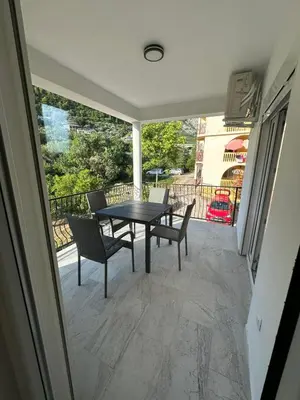 a patio with a table and chairs on a balcony at Apartmani Aki 4 in Bar