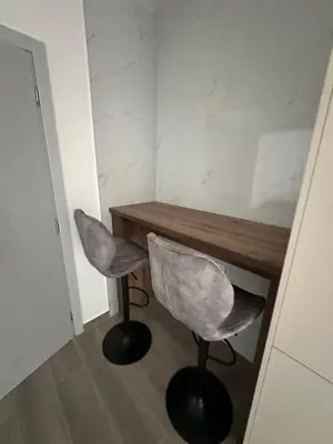 a room with a desk and two chairs in a room at Apartmani Aki 4 in Bar