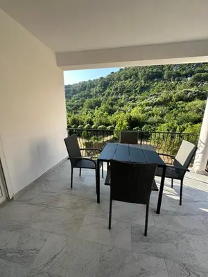 a table and chairs on a balcony with a view at Apartmani Aki 4 in Bar