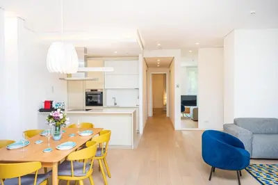 a kitchen and dining room with a table and chairs at Dukley Montesun Apartments in Budva