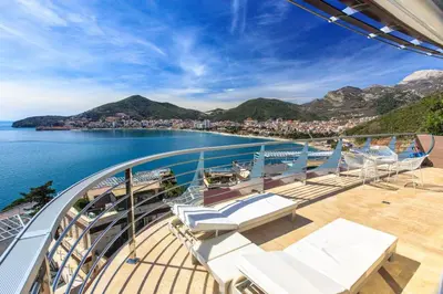 a balcony on a cruise ship with a view of the water at Dukley Montesun Apartments in Budva