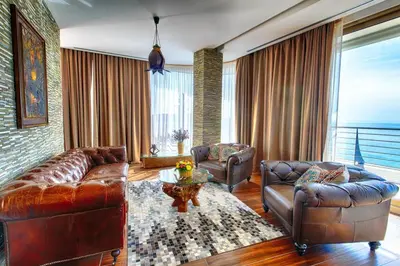 a living room with a leather couch and chairs at Dukley Montesun Apartments in Budva