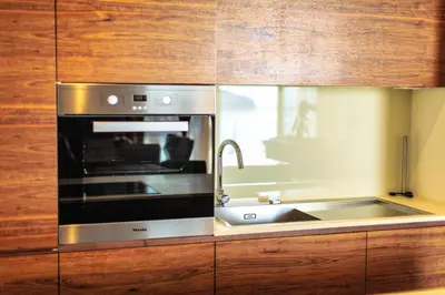 a kitchen with a stainless steel oven and a sink at Dukley Montesun Apartments in Budva