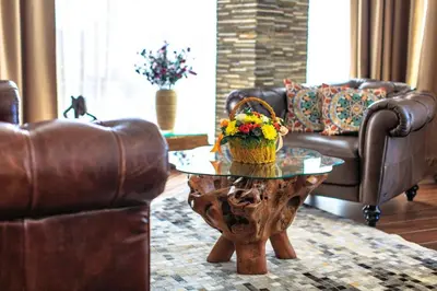 a living room with a table with a basket of flowers on it at Dukley Montesun Apartments in Budva