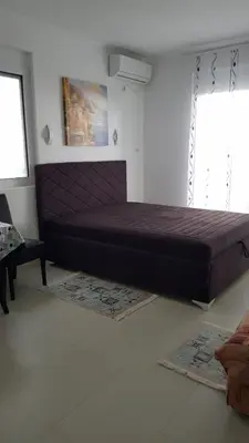 a large bed in a room with two rugs at Apartment 7 in Bar, Susanj