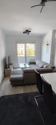 a living room with a couch and a table at Sea apartman in Bar