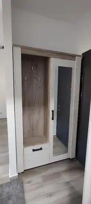 a dresser with a mirror in a room at Sea apartman in Bar