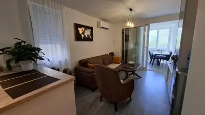 a living room with a couch and a table at Comfort in Budva